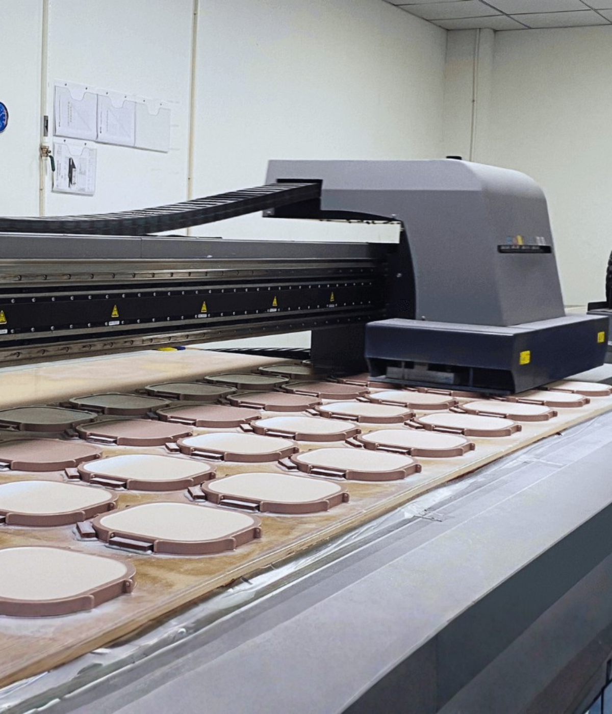 Professional UV printing workshop showcasing high-quality custom merchandise and large-format banner production